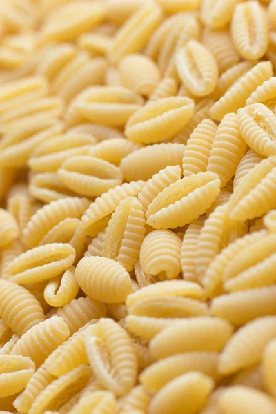 Pasta raw closeup background. Delicious dry uncooked ingredient for traditional Italian cuisine dish. Textured variety shapes. Top view. Copy space — Stock Photo, Image