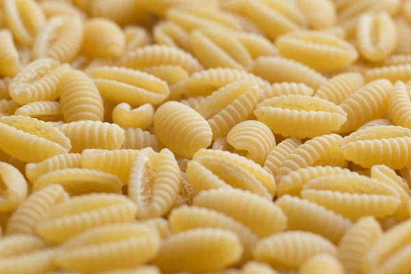 Pasta raw closeup background. Delicious dry uncooked ingredient for traditional Italian cuisine dish. Textured variety shapes. Top view. Copy space — Stock Photo, Image