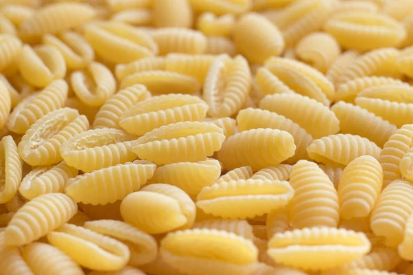 Pasta raw closeup background. Delicious dry uncooked ingredient for traditional Italian cuisine dish. Textured variety shapes. Top view. Copy space — Stock Photo, Image