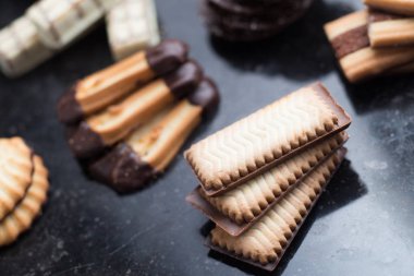 Siyah arka plan üzerine çeşitli kurabiyeler. Kahvaltı, Kahvaltı ve öğle yemeği için lezzetli sabah aperatifler. Apetisant, tatlı ve fast food