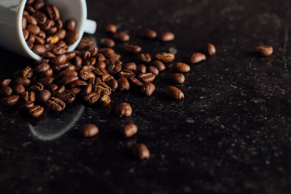 Espresso cup full of coffee on the grains pile. Italian traditional morning short drink on breakfast. Close-up. Toned