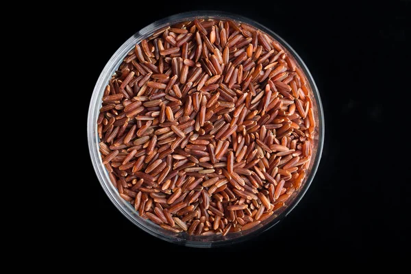 Red rice, grains closeup. Bhutanese. Unpolished, uncooked, natural, diet, raw for traditional asian cuisine, dish. Popular agriculture cereal. Texture pattern background, copy space — Stock Photo, Image