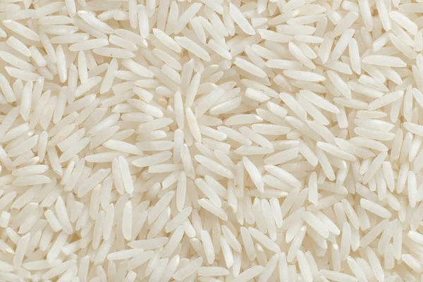 Rijst, witte korrels close-up. Basmati. Ongepolijste, ongekookt, natuurlijke, dieet, raw voor traditionele Aziatische keuken, schotel. Populaire landbouw granen, textuur patroon achtergrond kopie ruimte — Stockfoto