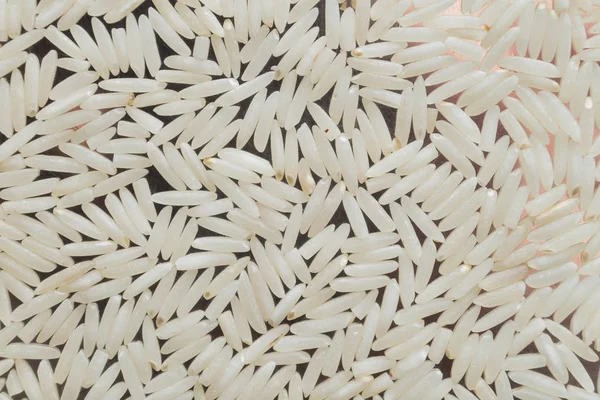 Rice, white grains closeup. Basmati. Unpolished, uncooked, natural, diet, raw for traditional asian cuisine, dish. Popular agriculture cereal, Texture pattern background copy space