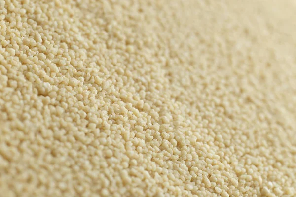 Couscous closeup. Bulgur. Uncooked, natural, diet, raw for traditional Middle East and Mediterranean cuisine, dish. Popular agriculture cereal. Texture pattern background, copy space