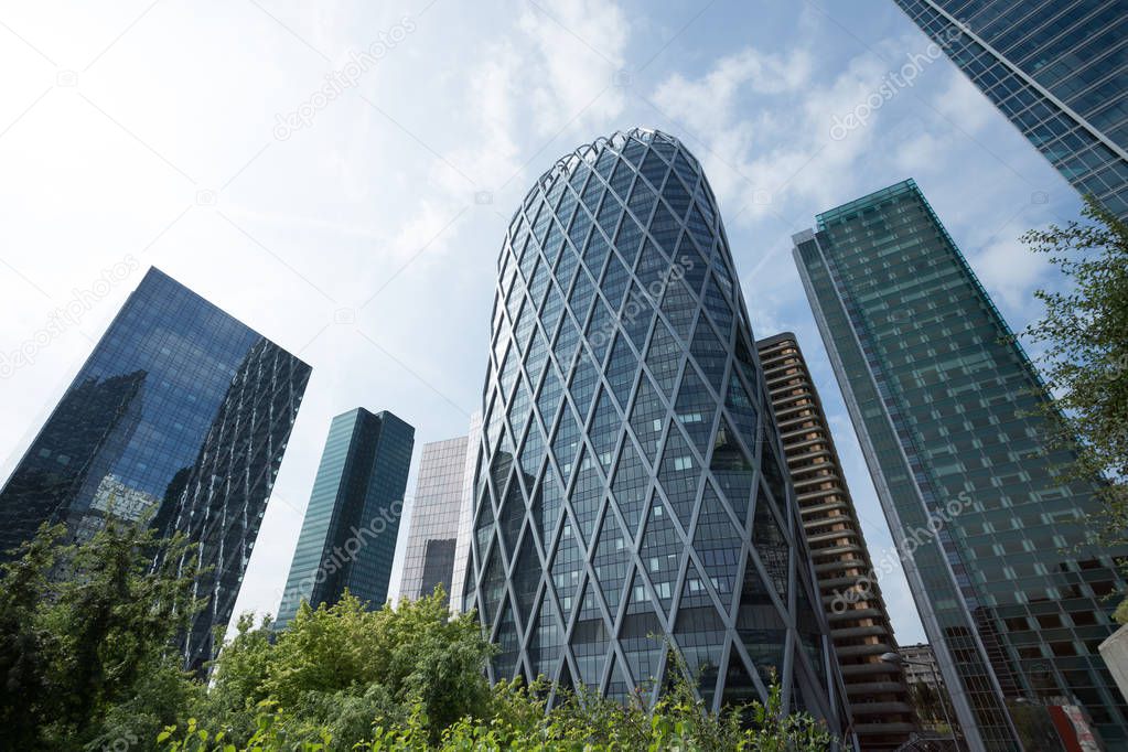 Skyscrapers in Paris business district La Defense. Cityscape with glass facades of modern buildings on a sunny day. Urban architecture and contemporary city life. Economy, financial activity concept