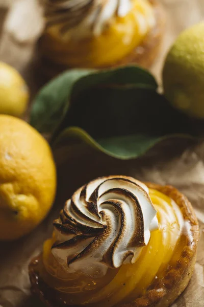 Torta de limão na mesa com frutas cítricas. Torta de pastelaria doce francesa tradicional. Deliciosa, apetitosa, sobremesa caseira com creme de limão. Espaço de cópia, close up. Foco seletivo. Tonificado — Fotografia de Stock