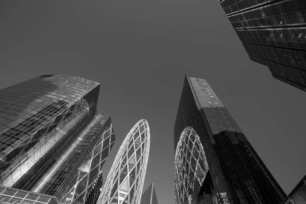 Skyscrapers in Paris business district La Defense. Cityscape with glass facades of modern buildings on a sunny day. Urban architecture, city life. Economy, financial activity concept. Black and white — Stock Photo, Image