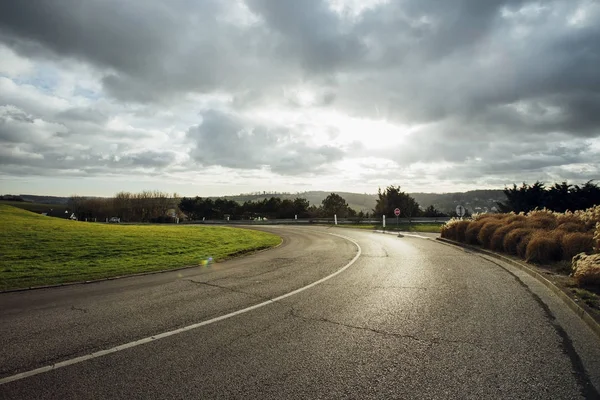 Asphalt road passing through the fields in the region of Normandy, France. Landscape in autumn sunny day. Toned — Stock Photo, Image