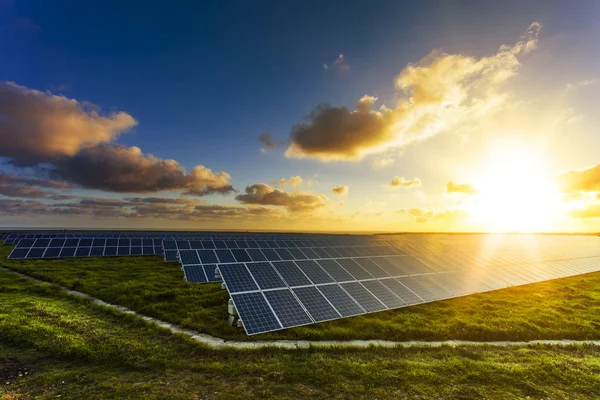 Solar panels at sunrise with cloudy sky in Normandy, France. Sol — Stock Photo, Image