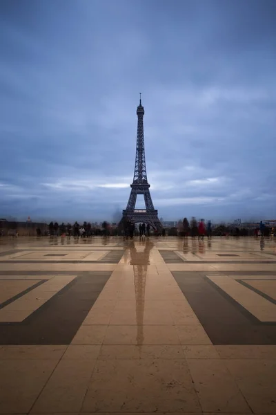 Eiffel tower, Paris symbol and iconic landmark in France, on a cloudy day. Twilight cityscape. Famous touristic places and romantic travel destinations in Europe. Tourism concept. Long exposure. Toned — Stock Photo, Image