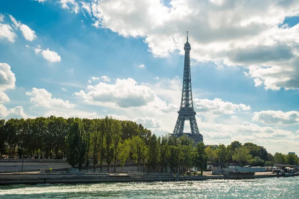 Torre Eiffel perto do rio Sena, símbolo de Paris e marco icônico na França, em um dia ensolarado brilhante. Lugares turísticos famosos e destinos de viagem românticos na Europa. Conceito de vida urbana e turismo — Fotografia de Stock