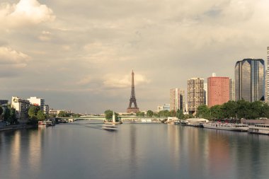 Eyfel Kulesi, ünlü Paris sembolü ve Fransa ve bulutlu bir günde Seine Nehri'ne yakın konut ikonik simgesel yapı. Avrupa, turizm ve şehir hayat kavramı içinde popüler seyahat hedef