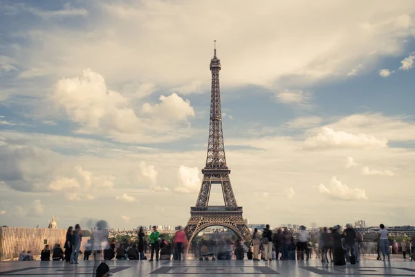 Eiffel tower, Paris symbol and iconic landmark in France, on a sunny day with clouds in the sky. Famous touristic places and romantic travel destinations in Europe. Tourism concept. Long exposure — Stock Photo, Image