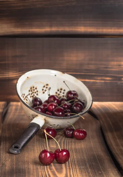 Cherry in a colander — Stock Photo, Image