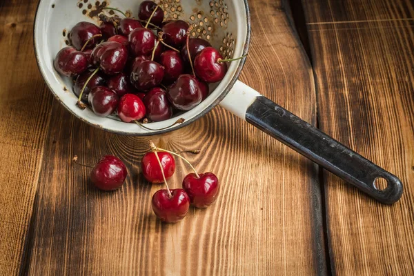 Cherry in a colander — Stock Photo, Image