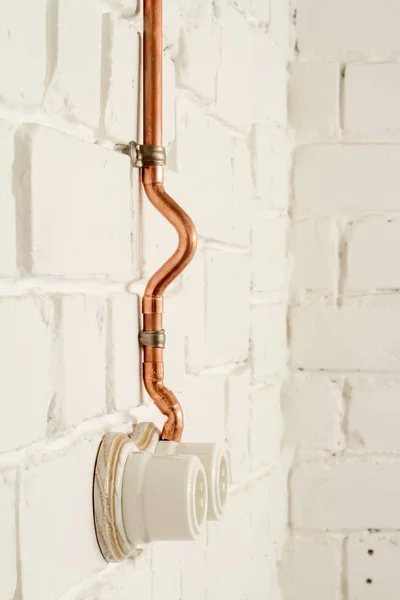 A vintage outlet and electrical wiring in a copper tube. — Stock Photo, Image