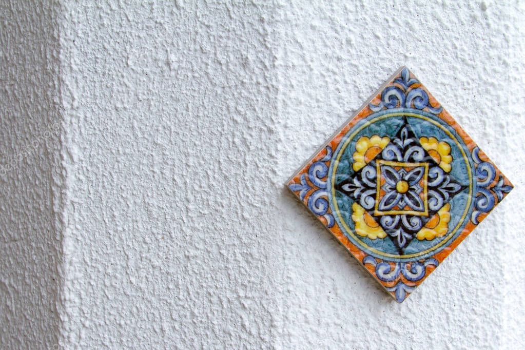 One ceramic tile with oriental pattern on a white background.