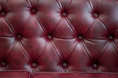 Closeup doku vintage kırmızı deri kanepe için arka plan ve