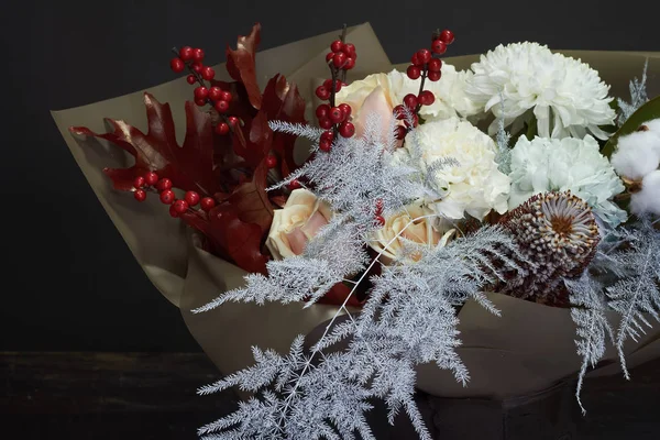 Christmas and New Year composition bouquet in a glass vase on a dark background, selective focus — Stock Photo, Image