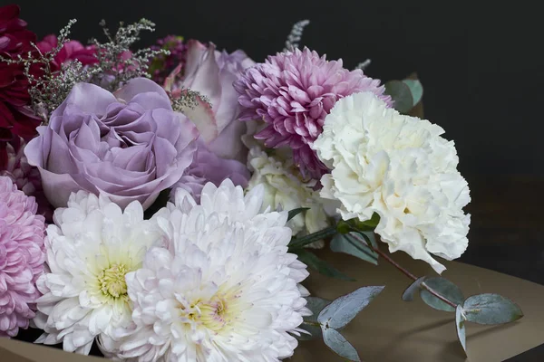 Pink and purple toned bouquet in vintage style on a dark background, selective focus