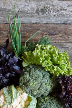 Eski pürüzlü ahşap yüzeyde taze sebze ve otlar, sağlıklı beslenme konsepti, seçici odak