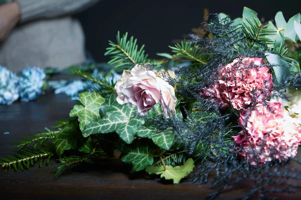 Close-up on the florist's table are flowers to form a bouquet to order, the concept of your own floristic salon