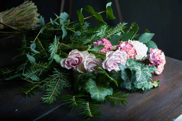 Close-up on the florist\'s table are flowers to form a bouquet to order, the concept of your own floristic salon
