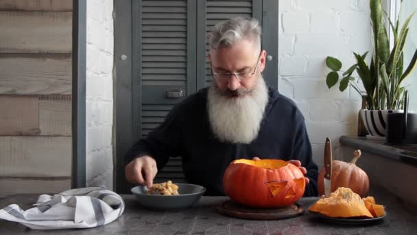 Caucasian Mature Bearded Man Makes Pumpkin Lantern Jack Lantern Markup — Stock Video