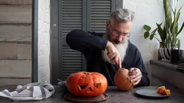 Caucasian Mature Bearded Man Makes Pumpkin Lantern Jack Lantern Markup — Stock Video