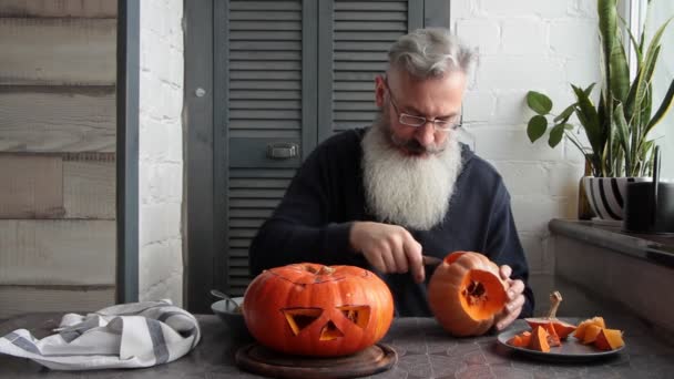 Caucasian Mature Bearded Man Makes Pumpkin Lantern Jack Lantern Markup — Stock Video