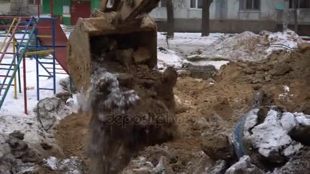 Excavator bucket digs the ground — Stock Video