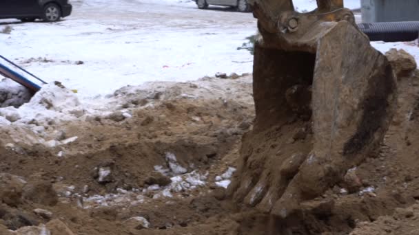 Excavator bucket digs the ground — Stock Video