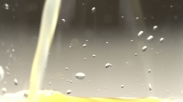 Orange juice is poured into a glass — Stock Video