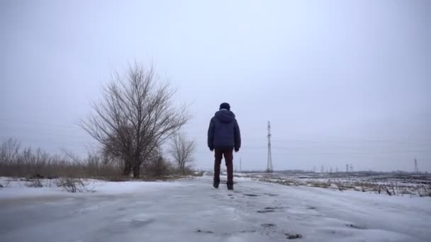 Garçon marchant sur la route gelée — Video