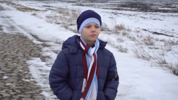 Boy walking on frozen road — Stock Video