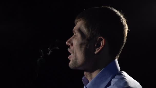 Un hombre fuma un cigarrillo electrónico — Vídeo de stock