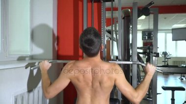 Atlet spor salonunda. Ağır çekim / erkek atlet trenler simülatör spor salonunda. Ağır çekim
