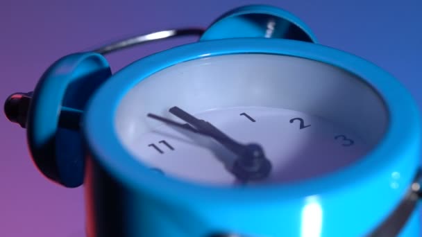 Alarm clock on a colored background — Stock Video