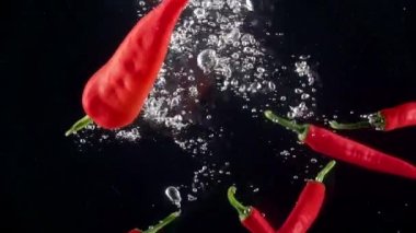 Acı biberler suya düşüyor. Yavaş çekim