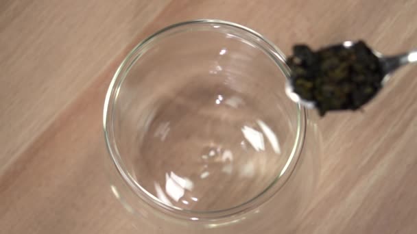 Häll tebladen i en glasmugg. Långsamma rörelser 500fps — Stockvideo