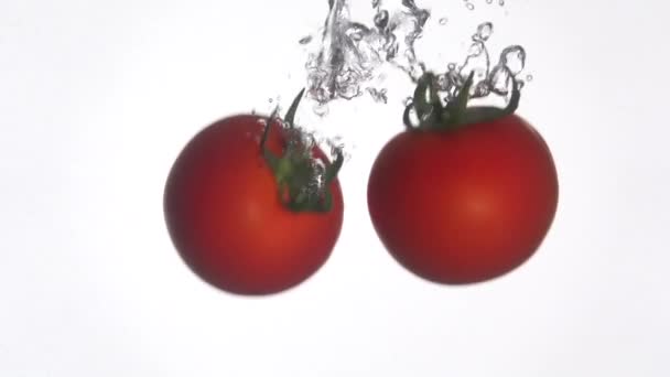 Os tomates caem na água. Movimento lento 250fps — Vídeo de Stock