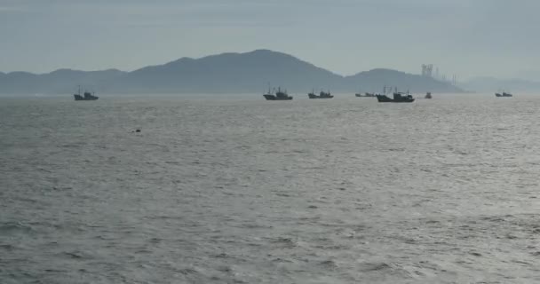 4k barcos flotando en el mar contra el fondo de la isla, grúa astillero distante . — Vídeos de Stock