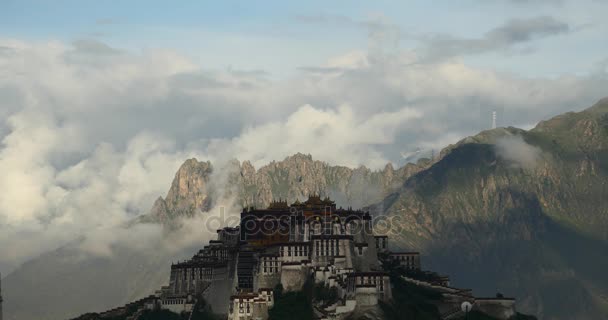 4k Potala Palace in the morning, mountains surrounded by clouds . — стоковое видео