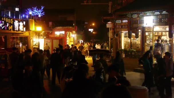 China-Oct 12,2016:Pedestrians walking at stone bridge Neon bars Commercial Street in BeiJing HouH — Stock Video