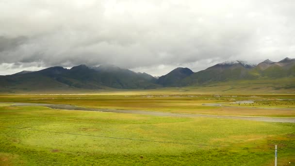 4k nubes rodando sobre la montaña del Tíbet, río que fluye a través de la pradera . — Vídeo de stock