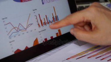 İşadamı tablet diyagramlarıyla Finans pasta grafikler dokunmadan parmak üzerinde çalışma.