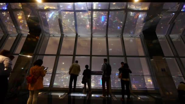 China-Sep 12,2016:Tourists aerial view of Shanghai night-scene in huanqiu sightseeing hall. — Stock Video