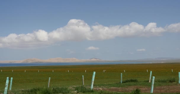 4k far away wide prairie & desert,white puffy cloud mass rolling over blue lake — Stock Video