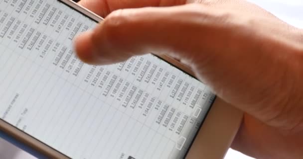 4k Businessman browsing financial news on smartPhone, finger touching finance pi — стоковое видео